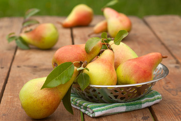 Pears on a rustic wooden kitchen table. Autumn concept
