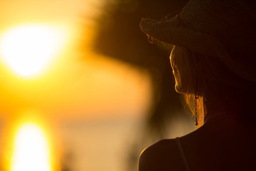 young woman staying back of the head in summer light