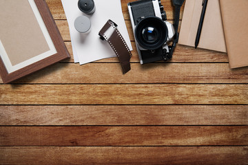 camera and supplies, Blank photo frames on wooden table