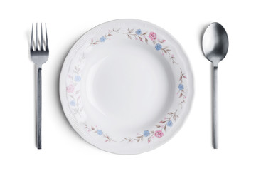 A white plate with silver fork and spoon