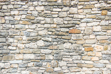 Close up of an ancient stone wall. Stone wall background.
