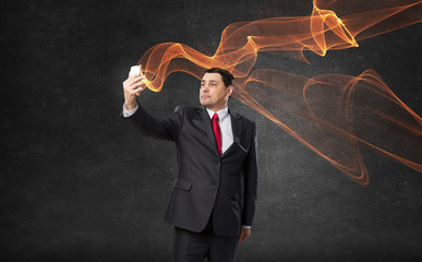 Businessman using smartphone . Mixed media