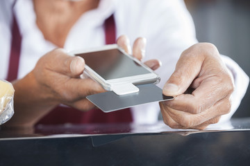 Salesman Swiping Credit Card On Mobile Phone
