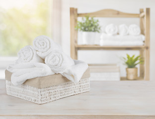 Spa towels on wood over abstract beauty salon room background