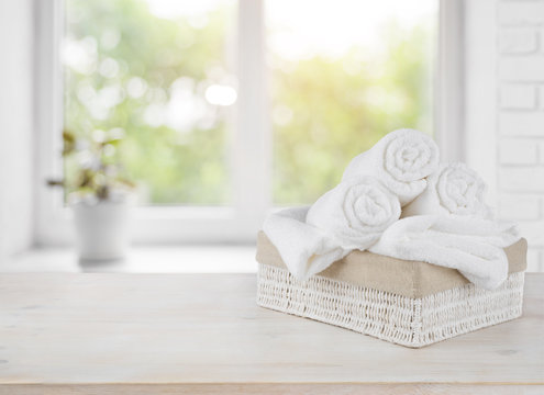 Basket with towels on window sill over summer day background