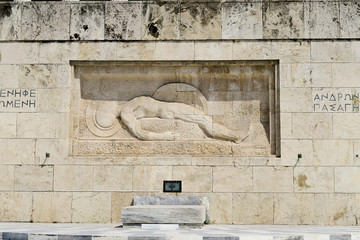 Athens, Greece. Tomb of The Unknown Soldier outside Greek Parliament. It depicts a dead soldier...