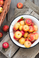Naklejka na ściany i meble Organic fruit. Freshly harvested apples on the rustic wooden background. Autumn season harvest. Top view