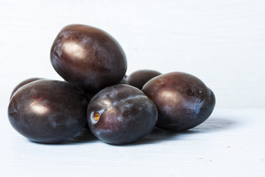 purple plums isolated on the white background