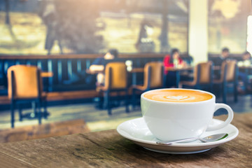 Coffee cup in coffee time on blur people in coffee shop backgrou
