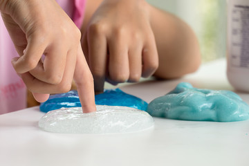 Obraz na płótnie Canvas Kid Playing Hand Made Toy Called Slime