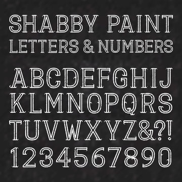 White capital letters and numbers of shabby paint on a black marble surface. Outline font with cracks. Type in grunge style. Isolated alphabet.
