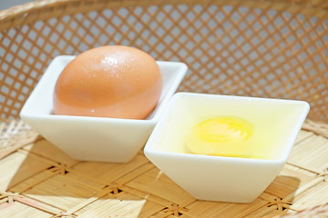 Chicken Eggs on White Ceramic Bowl in Rattan Basket