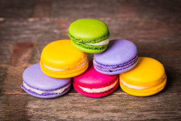 Fresh macaroons on wooden table ,vintage filter