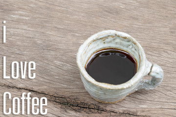 Ceramic cup of black coffee on wood table