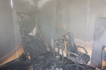 chair and furniture in room after burned by fire with smoke and