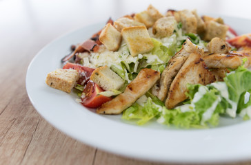 Fototapeta na wymiar Caesar salad on wooden table closeup
