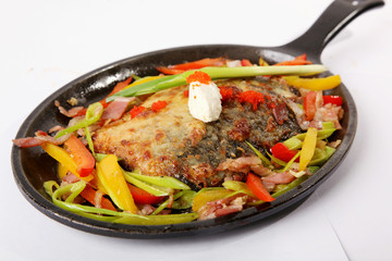 fried fish in black metal pan