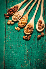 Fototapeta na wymiar Mix nuts on wooden table,healthy vegan food.