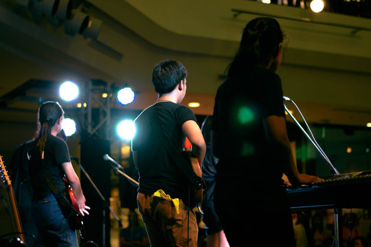People play music on stage.