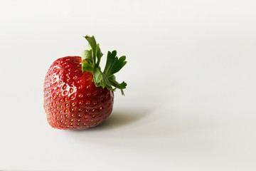 Red ripe strawberry on white.