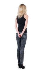 Obraz premium Beautiful young woman looking at wall. Rear view.