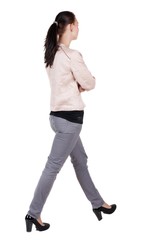 back view of walking  woman in jeans . beautiful brunette girl in motion.  backside view of person.  Rear view people collection. Isolated over white background. 