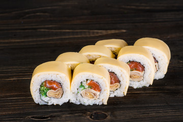 Sushi roll on wooden background . They were 8 pieces .