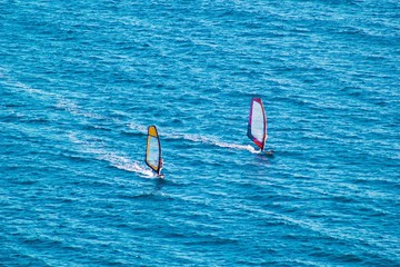 Surfers on blue sea