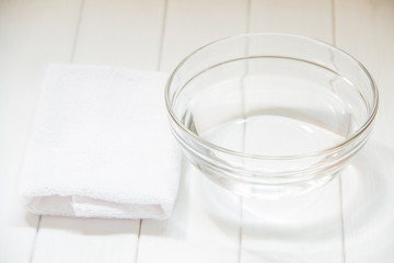 A towel and a glass bowl of water