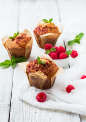 Fresh muffins with raspberry on a rustic table for breakfast