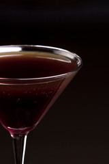 Alcoholic cocktail standing on a wooden table . 