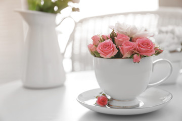 Flower bouquet of rose and chrysanthemum in cup on table