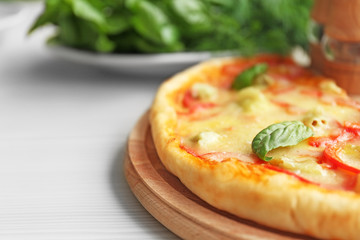 Delicious pizza on wooden cutting board