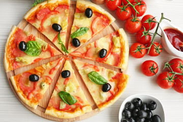 Delicious pizza on wooden cutting board