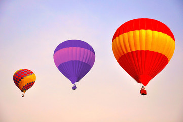 Colorful hot air balloons flying at sunrise