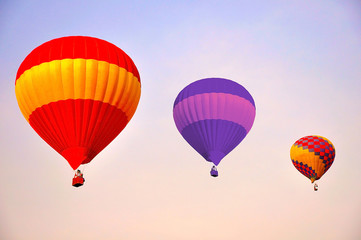 Colorful hot air balloons flying at sunrise