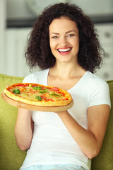 Beautiful young woman with tasty pizza