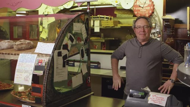 Small business owner at cash register - 4K