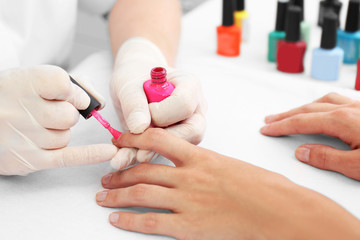 Obraz na płótnie Canvas Woman getting a manicure in a beauty salon, close up