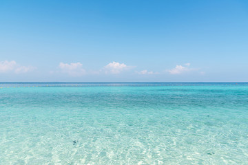 Fototapeta na wymiar Beautiful white sand on Tropical beach blue water and blue sky