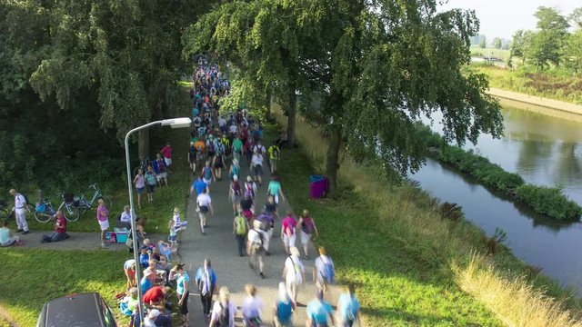 Crowd of people walking along a canal during the four-days marches Nijmegen (Vierdaagse), Netherlands, 4K time lapse