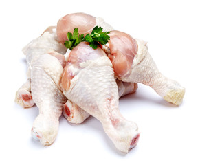 Raw chicken legs on a white background