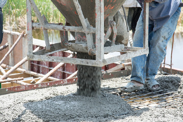 worker pouring  concrete  works at construction site