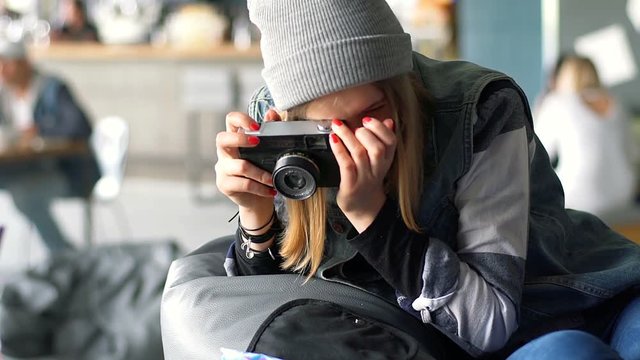 Hpster girl doing photo of pizza on old camera, steadycam shot

