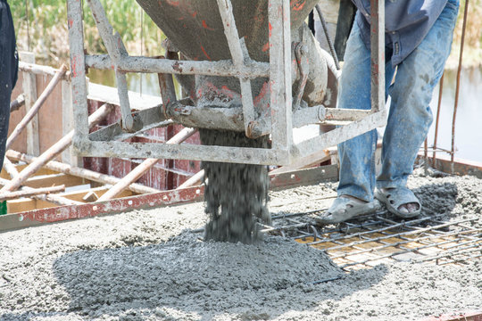 worker pouring  concrete  works at construction site