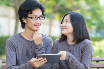 Couple Use Tablet at Park