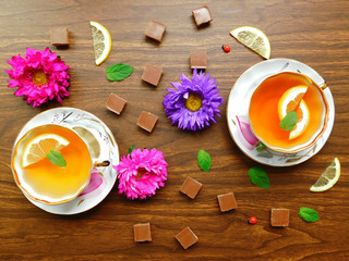 Obraz na płótnie Canvas Composition made of teacups,chocolate and fresh flowers. 