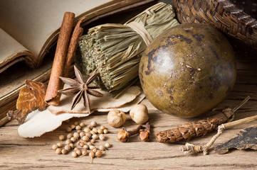 still life photography : various herb and spice with old reference book on old wood