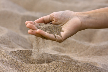 sand running through fingers