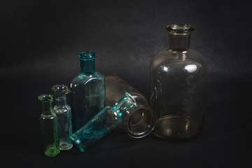 Empty bottles are shown on a dark background